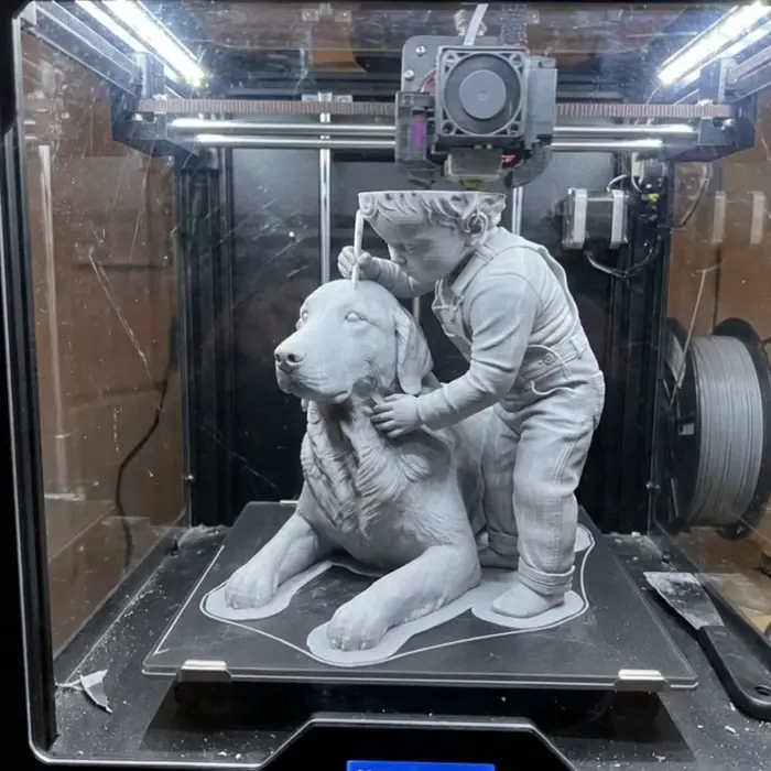 The piece part-way through printing on the build plate, layer lines visible