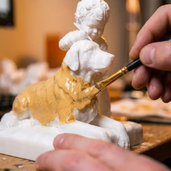 Hand-painting the printed figure, detail by detail